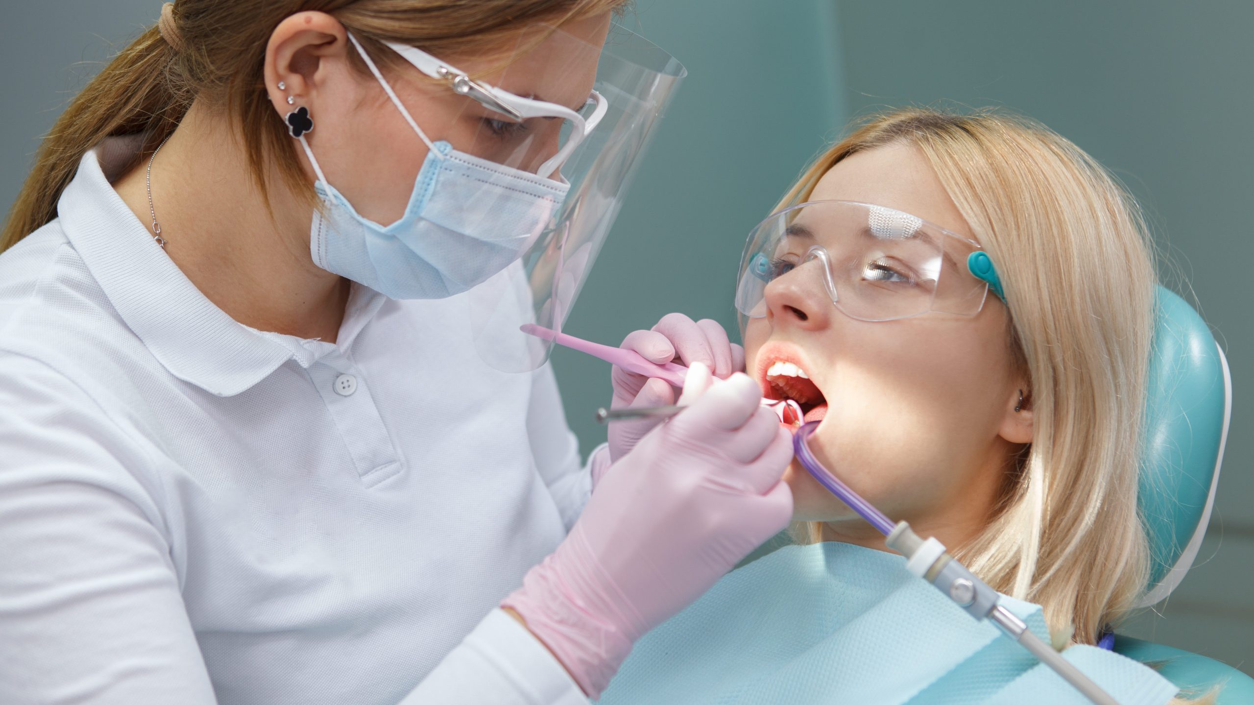 Lovely young woman having dental examination