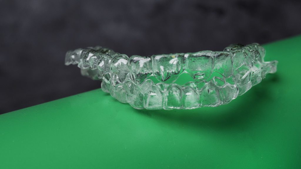 Invisible teeth retainers orthodontic brackets. Plastic modern straighterners to correct tooth alignment