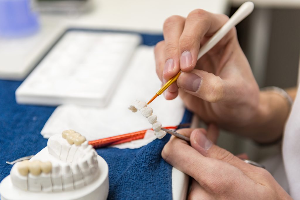 Prosthetic dentistry technician working in his office